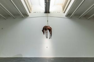 Maurizio Cattelan, _Novecento_ (1997). Taxidermied horse, leather saddlery, rope, pulley, 201 × 271 × 68 cm. Exhibition view: Maurizio Cattelan, _The Last Judgment_, UCCA, Beijing (20 November 2021–20 February 2022). Courtesy UCCA Center for Contemporary Art.